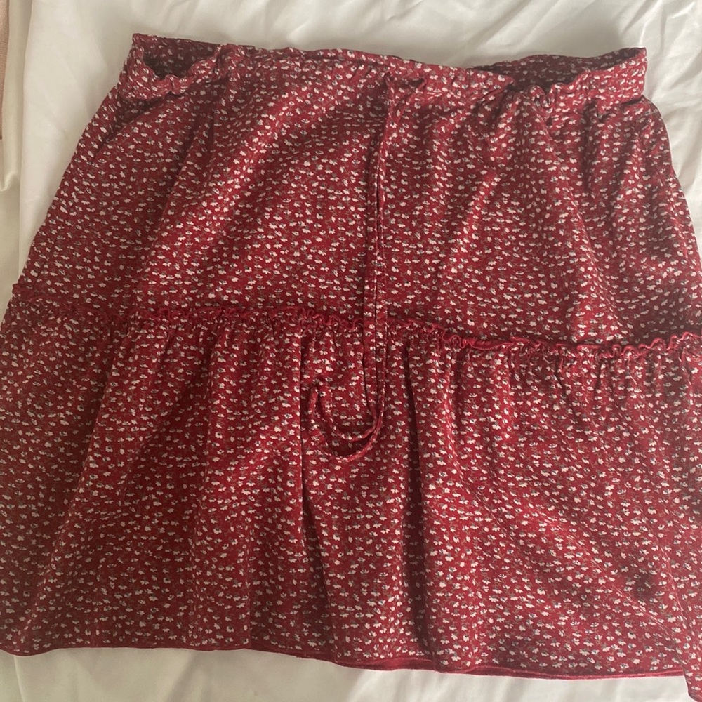 Red Brandy skirt with small flower detail. Adjustable sizing, price adjustable